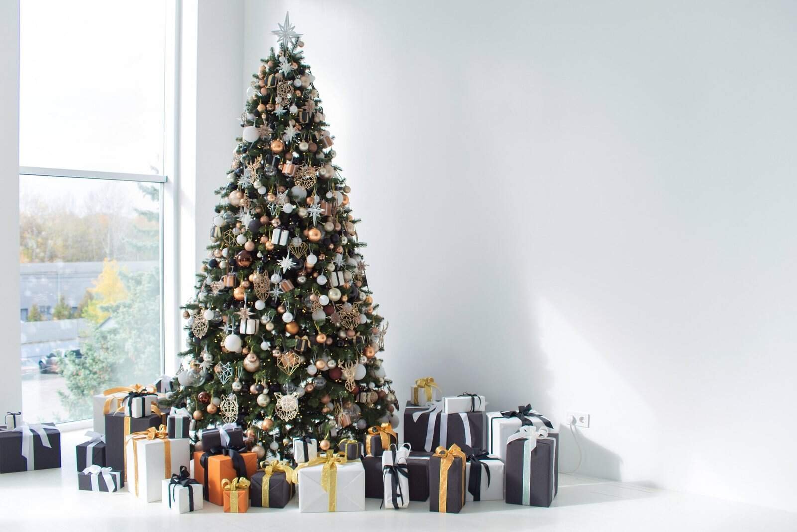 10 Modern Christmas Tree Decor Ideas 2 a christmas tree with presents and presents on a white floor