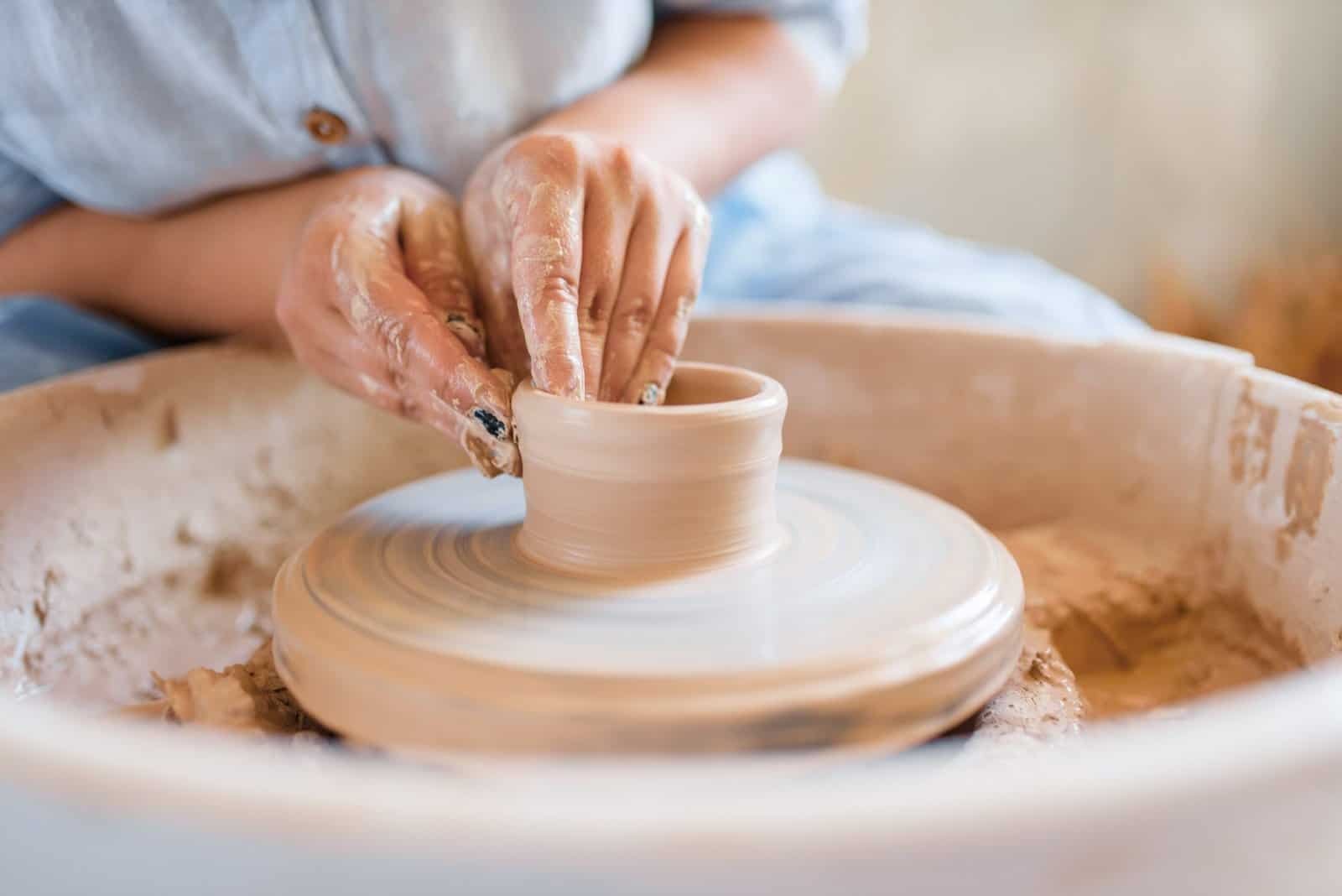 a person is making a clay potted potted with clay