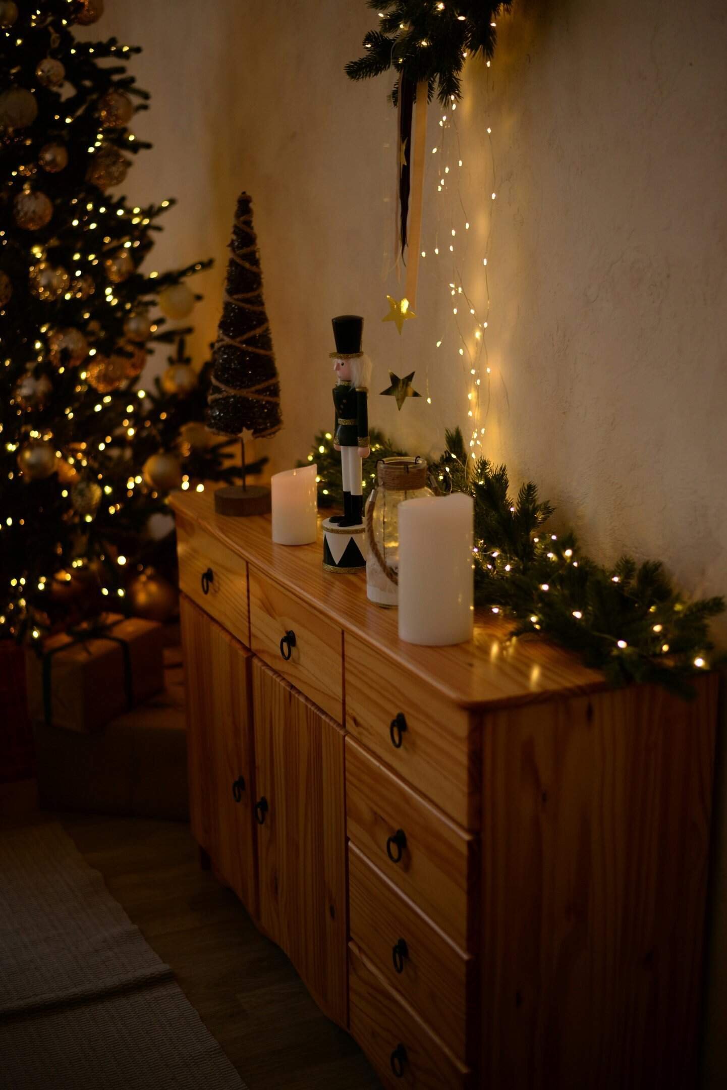 a christmas tree with candles and candles on a dresser